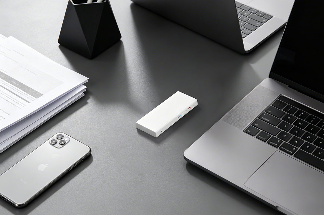 Echo Mini portable AI note taker on a desk with laptop and phone