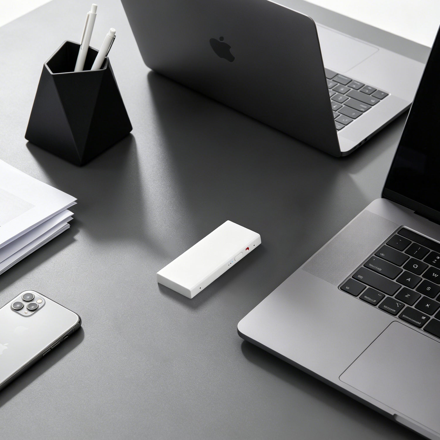 Echo Mini portable AI note taker on a desk with laptop and phone